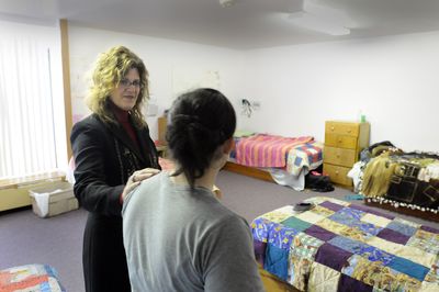 Daybreak Development Director Kathy Kramer, left,  talks with a young resident in one of the bedrooms, where most of the beds are now covered with quilts made by a volunteer group. Daybreak is a drug and alcohol treatment program for teens. (Jesse Tinsley / The Spokesman-Review)