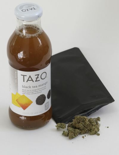 A bottle of tea and marijuana from HighSpeed juice delivery service rest together Thursday, Dec. 21, 2017, in Walpole, Mass. Companies like HighSpeed have been exploiting a provision that allows people to exchange up to an ounce of marijuana, so long as it's given away or 