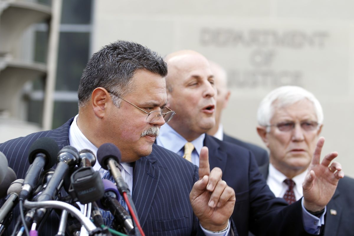 Tucson, Ariz., Chief Roberto Villasenor, left, accompanied by Chuck Wexler of the Police Executive Research Forum, center, and Sahuarita, Ariz., police Chief John W. Harris, addresses  a news conference outside the Justice Department  following a meeting Wednesday with Attorney General Eric Holder.  (Associated Press)