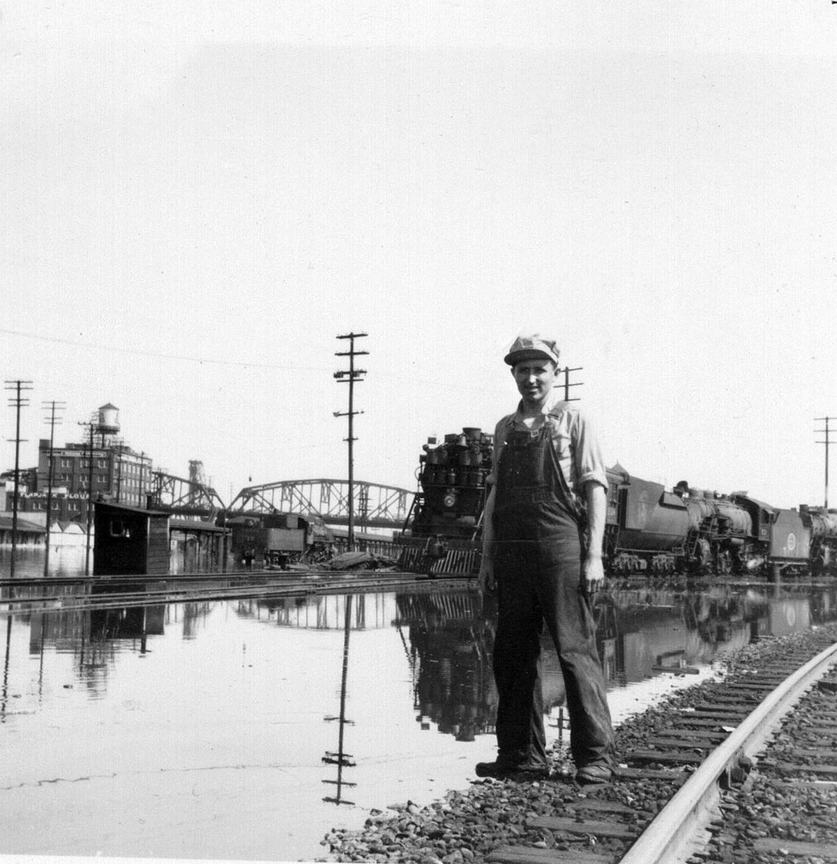 Kenny Prager poses in front of locomotives in the Spokane, Portland & Seattle rail yard in Portland during the May 1948 flood that wiped out the city of Vanport, Ore. (Courtesy of Mike Prager)