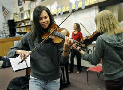 
Kelly McNamee, one of the area's top high jumpers in history, rehearses with fellow Ferris violinist Kelsey Richards, right. 
 (Dan Pelle / The Spokesman-Review)