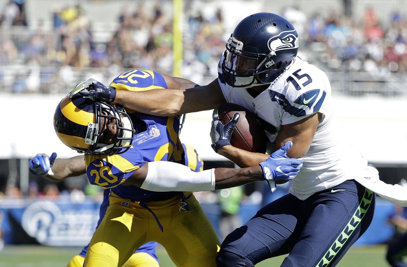 Seattle Seahawks wide receiver Jermaine Kearse, right, pushes Los Angeles Rams cornerback Lamarcus Joyner away as he runs the ball during the second half of Sunday’s game in Los Angeles. (Jae Hong / Associated Press)