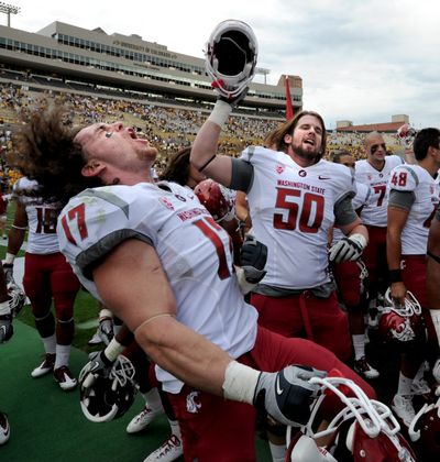 WSU linebacker Alex Hoffman-Ellis (17) and lineman Taylor Meighan (50) let the emotions out during a 31-27 win over Colorado. (Associated Press)