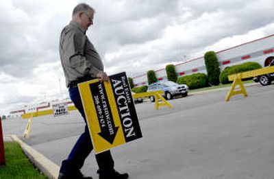 
Randy Wells, with his wife, Annette, owns MR Auction and Realty Auction Services in Post Falls. .
 (Kathy Plonka / The Spokesman-Review)