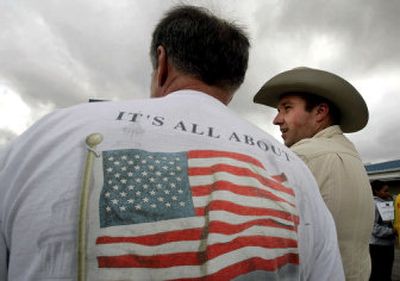
Dominik Rochwal, right, and his cousin Peter Rochwal take part in a rally in support of President Bush on Saturday near the president's ranch. 
 (Associated Press / The Spokesman-Review)