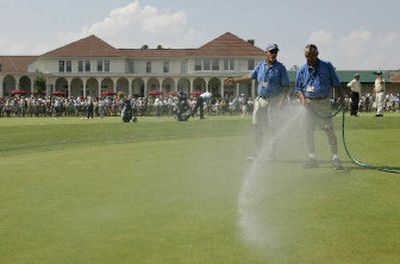 
Members of the grounds crew water the practice green in front of the Pinehurst Resort clubhouse during practice Wednesday for the U.S. Open.
 (Associated Press / The Spokesman-Review)