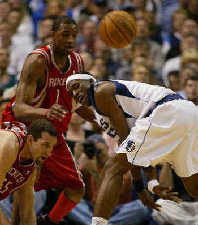 
Mavericks forward Josh Howard, right, passes the ball between his legs in the first quarter of Game 7.
 (Associated Press / The Spokesman-Review)