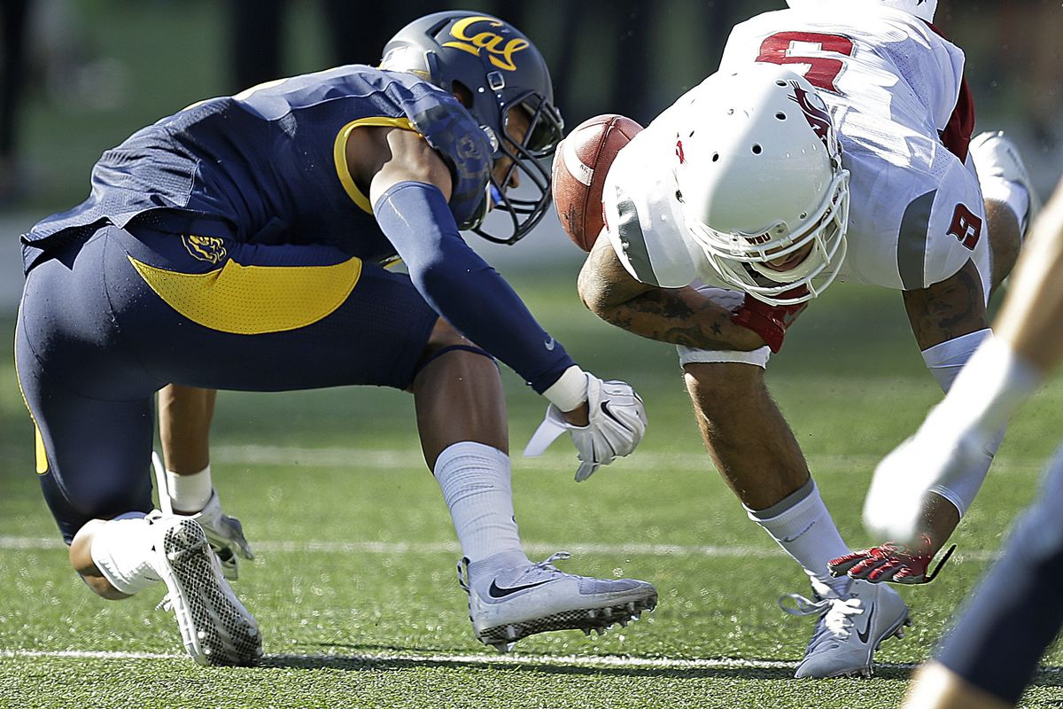 Washington State’s Gabe Marks, right, is stripped of the ball by California’s Darius White. (Associated Press)