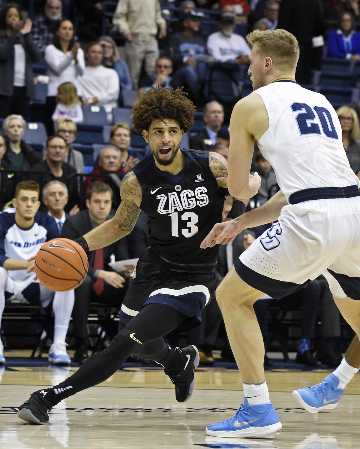 Gonzaga guard Josh Perkins (13) drives past San Diego forward Cameron Neubauer (20) during the first half of an NCAA college basketball game Thursday, Feb. 22, 2018, in San Diego. (Denis Poroy / Associated Press)