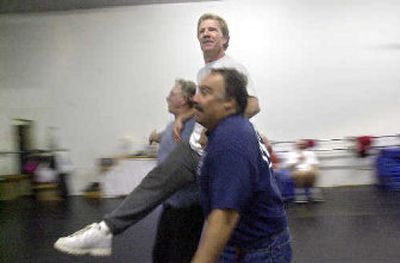 
Jim Armbruster, center, is carried across the dance floor by Jerry Porter, left, and Peter Mico during a rehearsal for a performance by  the Big Boy Ballet Co.
 (File / The Spokesman-Review)