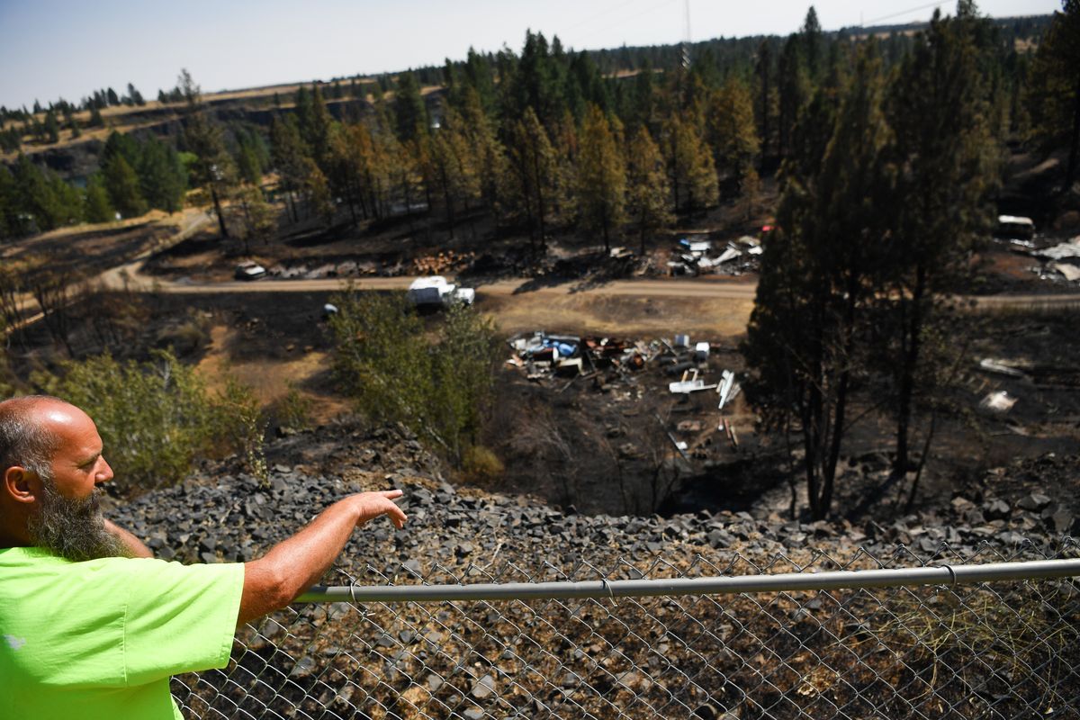 Peter Christianson shows the direction the Badger Lake fire came before it nearly destroyed his home Sunday evening on Wednesday, August 19, 2020, near Badger Lake outside Cheney, Wash.  (Tyler Tjomsland/THE SPOKESMAN-RE)
