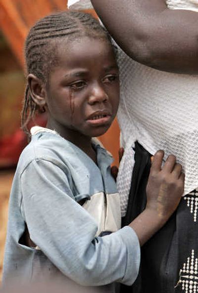 
A Kenyan child cries as she holds on to her mother, as they seek refuge at a police station on the outskirts of Nairobi on Friday. 
 (Associated Press / The Spokesman-Review)
