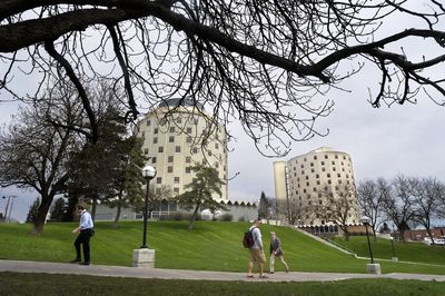 Students, staff and faculty at Eastern Washington University walk through the Cheney campus  Wednesday. In the background are Dressler, on the left, and Pearce residence halls. Budget writers on Wednesday agreed to increase college tuition. (CHRISTOPHER ANDERSON / The Spokesman-Review)