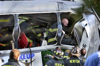 
Rescue workers arrive at a train accident during the evening rush hour in Newton, Mass., Wednesday. The 24-year-old operator of one train was killed, authorities said. Associated Press
 (Associated Press / The Spokesman-Review)