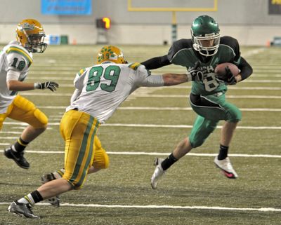 Tumwater's Zach Wimberly can't keep Adam Talley of East Valley out of the end zone, but the Knights lost 63-27.