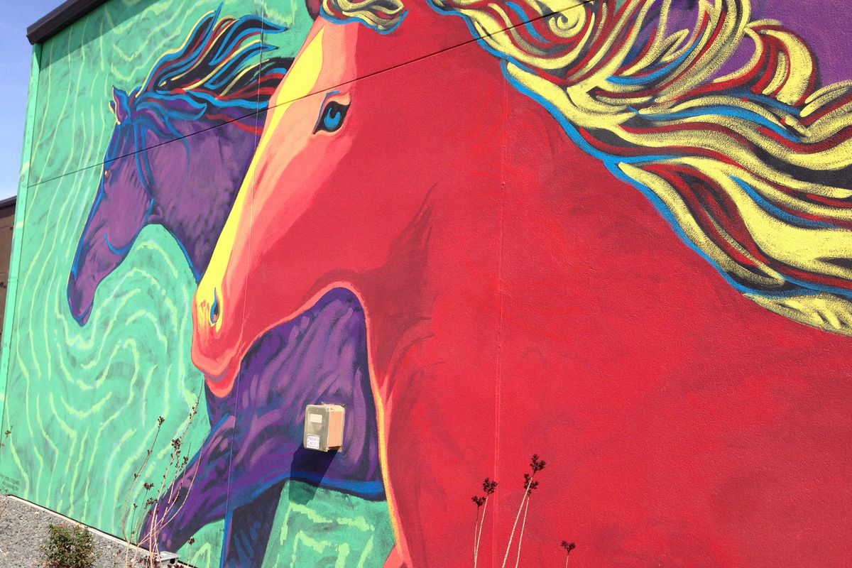 A mural depicting wild horses that once roamed central Washington adorns a wall at 14 Hands Winery in Prosser, Wash.