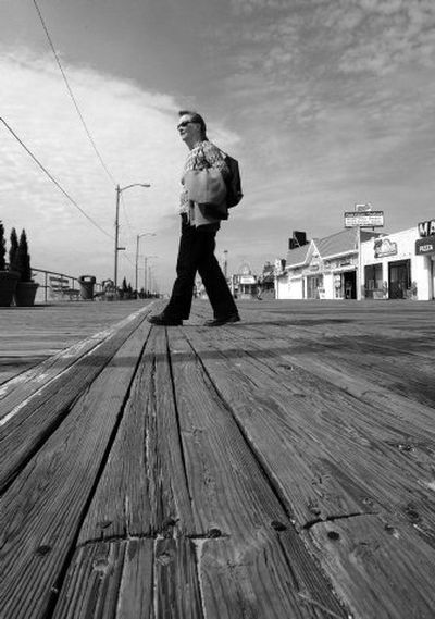 
Georgina Shanley walks across the worn boards of the boardwalk in Ocean City, N.J., on March 28. The town wants to use wood from Brazil's rain forests  to repair the boardwalk. 
 (Associated Press / The Spokesman-Review)