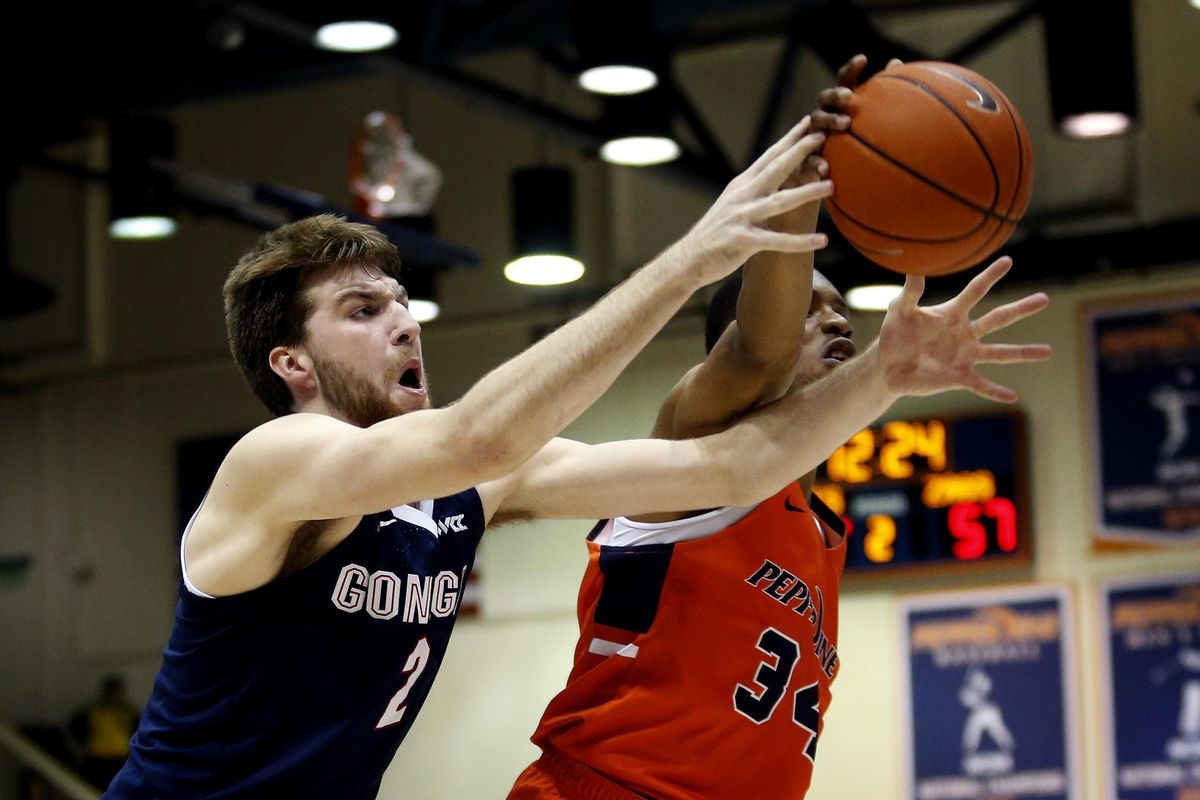 Gonzaga forward Drew Timme (2) and Pepperdine center Victor Ohia Obioha (34) reach for the ball during the second half of an NCAA college basketball game Saturday, Feb. 15, 2020, in Malibu, Calif. (Ringo H.W. Chiu / AP)