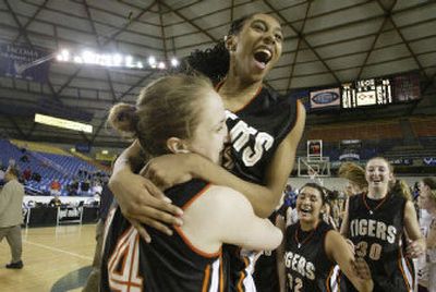 Most Valuable Player Heather Bowman hoists Lewis and Clark teammate Brittany Kennedy after winning the school's first girls State 4A basketball title.
(Jim Bryant Special to / The Spokesman-Review)