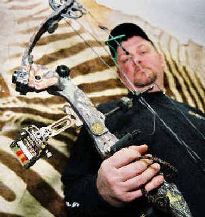 
Dan Syfert of Grants Pass, Ore., displays a customized high-tech bow with fiber-optic sights.
 (Associated Press / The Spokesman-Review)