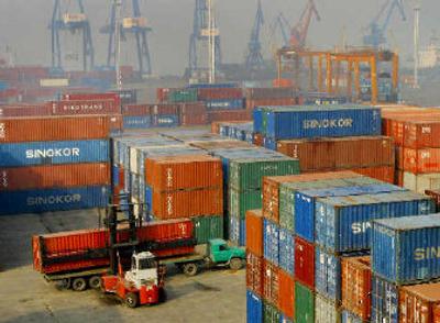 
Containers are piled up on a dockyard in Nanjing in east China's Jiangsu province on Wednesday China's trade surplus surged to $101.88 billion in 2005. 
 (Associated Press / The Spokesman-Review)
