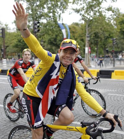Cadel Evans, cycling down the Champs-Elysses, became the first Australian to win the Tour. (Associated Press)