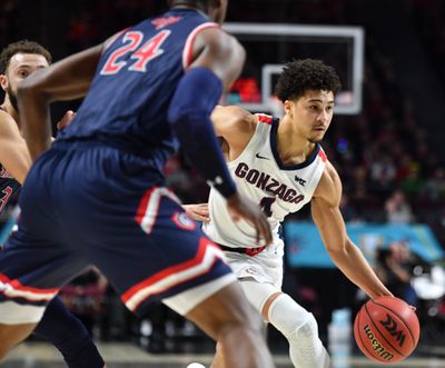 Gonzaga guard Ryan Woolridge drives against Saint Mary's Gaels forward Malik Fitts during the first half of a West Coast Conference championship basketball game in March.  (Tyler Tjomsland / The Spokesman-Review)