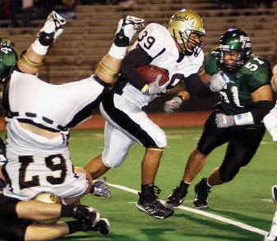 
Idaho's Willie Sipoloa (39) drives against Derek Mendoza (51) as UI lineman Tony Kiel (67) goes head-over-heels. 
 (Associated Press / The Spokesman-Review)