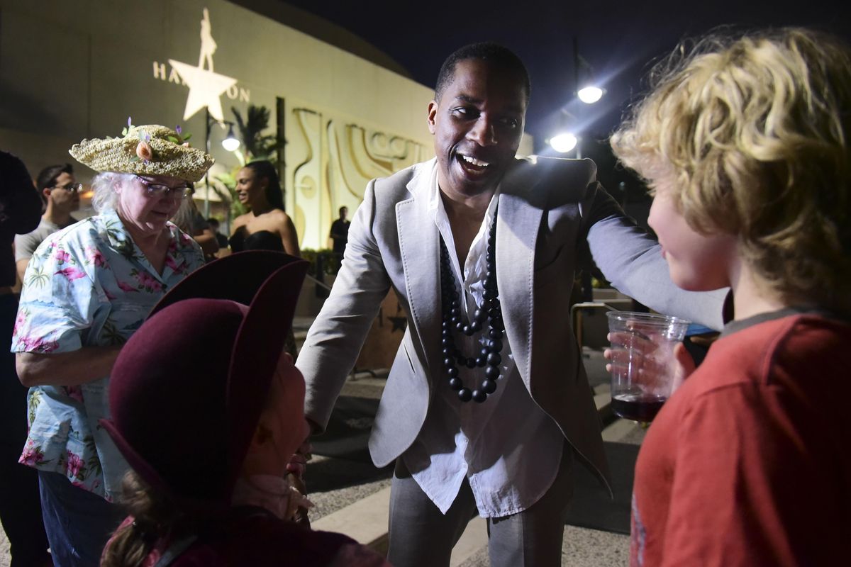 Leslie Odom Jr., the actor that plays the role of Aaron Burr in the Broadway musical “Hamilton,” greets people at the entrance plaza of the Santurce Fine Arts Center moments before the premiere of the Tony award-winning show, starring its creator, New York native of Puerto Rican descent Lin-Manuel Miranda, in San Juan, Puerto Rico, Friday Jan. 11, 2019. The musical is set to run for two weeks and will raise money for local arts programs. Odom received a Tony award in 2016 for best leading actor in a musical for his role as Burr. (Carlos Giusti / Associated Press)