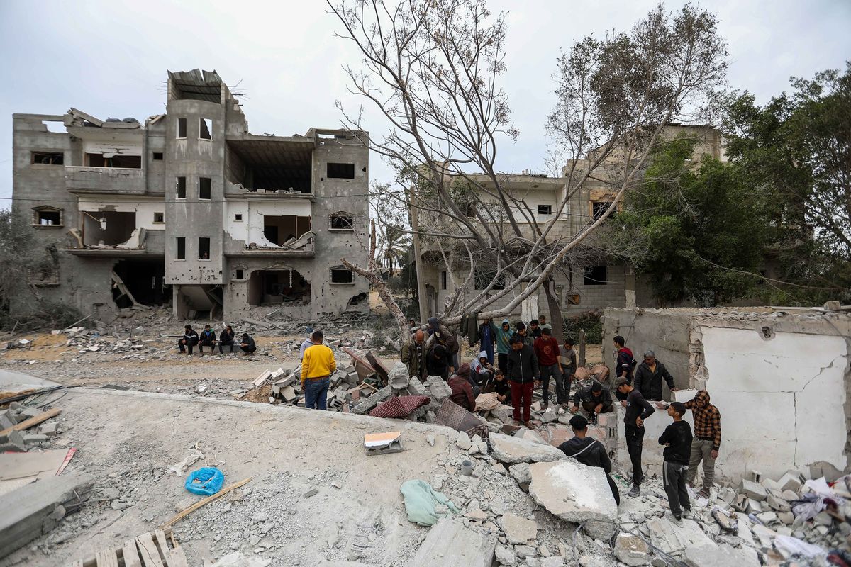 People inspect damage and search damaged buildings following Israeli air strikes on March 29, 2024, in Rafah, Gaza.    (Ahmad Hasaballah/Getty Images Europe/TNS)