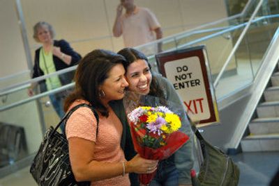 Diane Daugherty, left, is reunited with Isabella Caldas at Spokane International Airport. Caldas was a foreign exchange student who lived with Daugherty in 2003. 
 (Brian Plonka / The Spokesman-Review)