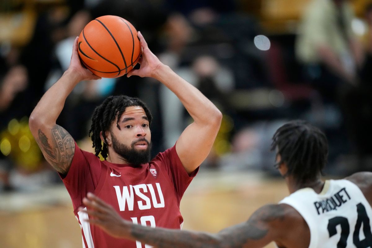 Washington State guard Michael Flowers, left, looks to pass the ball as Colorado guard Elijah Parquet defends in the first half of an NCAA college basketball game Thursday, Jan. 6, 2022, in Boulder, Colo. (AP Photo/David Zalubowski)  (David Zalubowski)