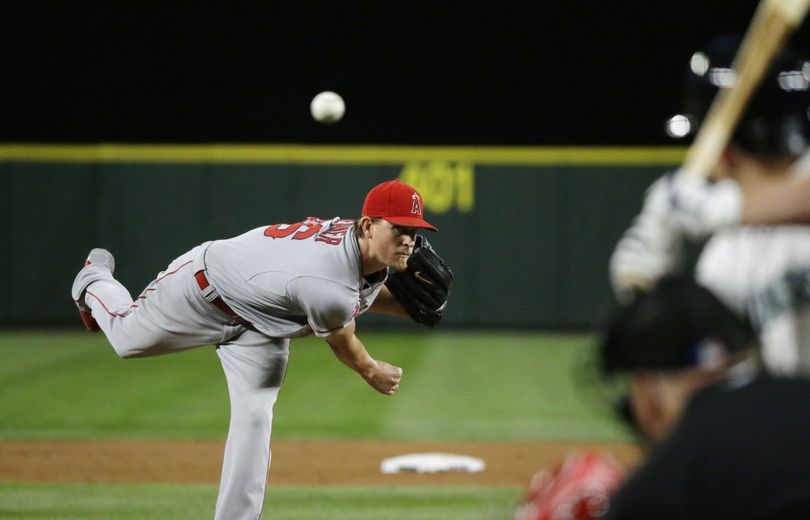 Angels starting pitcher Jered Weaver throws the pitch that hit Seattle’s Kyle Seager in the fifth inning Wednesday. (Associated Press)