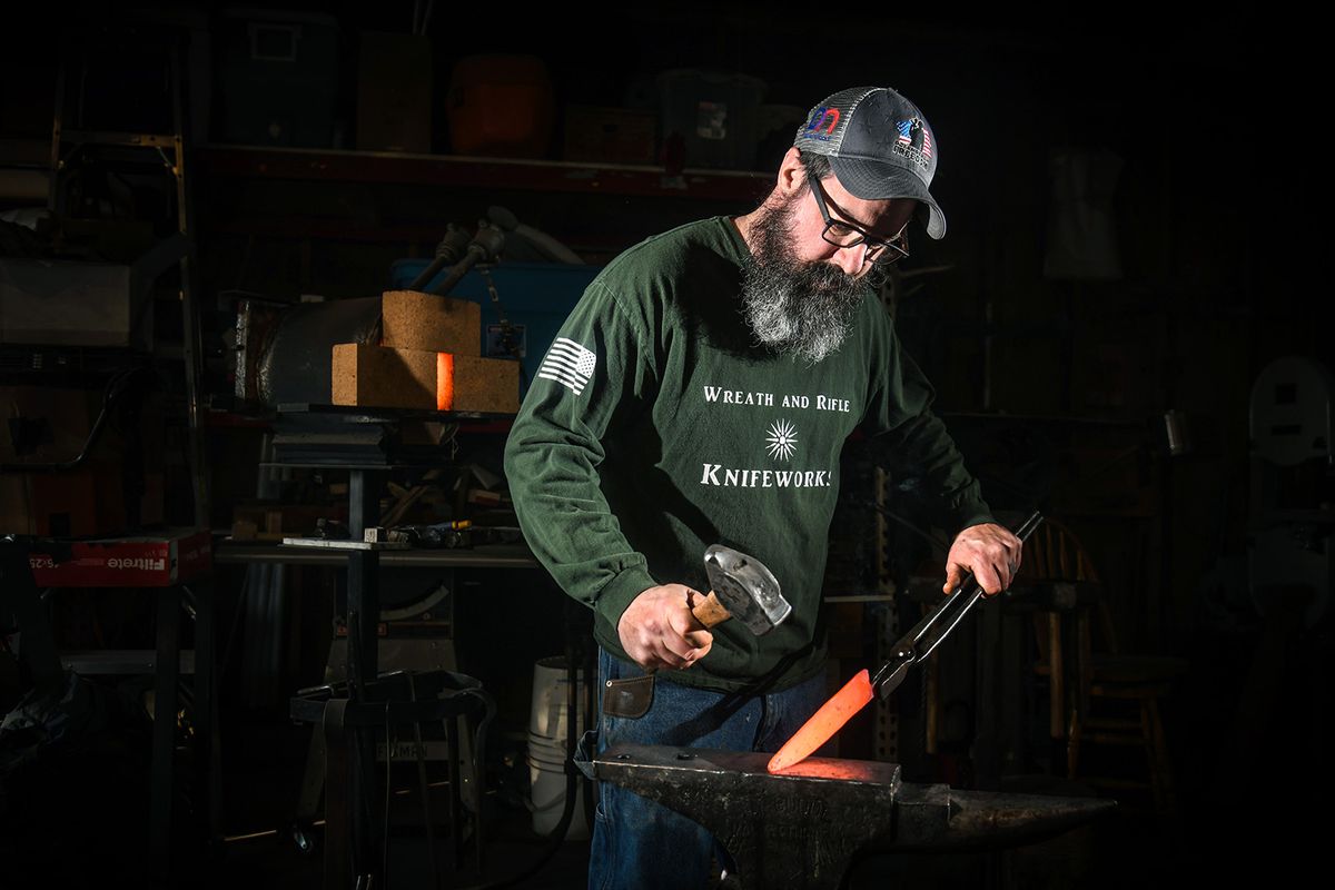Operation Iraqi Freedom veteran Ben Hayhurst, 42, suffered PTSD and multiple injuries but a few years ago started making Damascus steel knives primarily for service members. In September, he also finished what’s called the Spartan Axe by layering in 417 pieces of steel from the World Trade Center and a fireman’s ax.  (Dan Pelle/THE SPOKESMAN-REVIEW)
