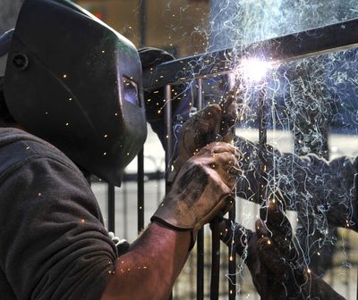 Restaurant’s pieces coming together: John Cowger, 34, makes a tack weld on a steel upright bar as he helps construct a section of fencing Tuesday at the Gust House on the corner of Pacific Avenue and Cannon Street in Browne’s Addition. The house, built in the 1890s, is being converted into EJ’s restaurant. Owners hope to open the eatery by May. (Dan Pelle)