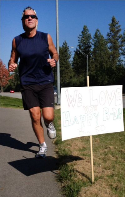 Keith Erickson takes a 12-mile run on his 50th birthday in October. His wife and daughter lined the Coeur d’Alene route with birthday signs.