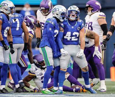 Seahawks linebacker Drake Thomas, right celebrates his tackle for loss with Devon Witherspoon during a game against the Vikings on Nov. 30, 2025, at Lumen Field in Seattle.  (Tribune News Service)