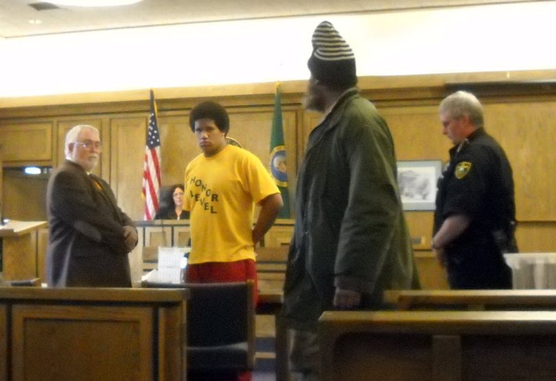  John C.  Palmer, 17, second from left, stands in court Thursday, Jan. 14, 2010 and faces his victim, Peter Krueger, second from right, who  Palmer set fire to while Krueger was sleeping at a homeless camp near downtown Spokane in 2009.  Palmer was sentenced to 10 years. MEGHANN  CUNIFF meghannc@spokesman.com (Meghann M. Cuniff / The Spokesman-Review)
