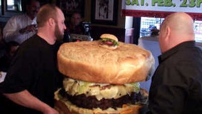 
Michael Berry, left, and Steve Mallie put a burger on a scale at Mallie's Sports Bar & Grill in Southgate, Mich., on Saturday, hoping to set a new world's record for the heaviest hamburger. Associated Press
 (Associated Press / The Spokesman-Review)