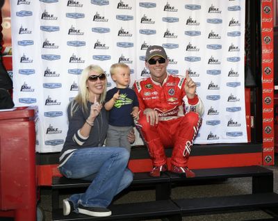 Kevin Harvick poses with his son, Keelan, and wife, DeLana, after he won the pole. (Associated Press)