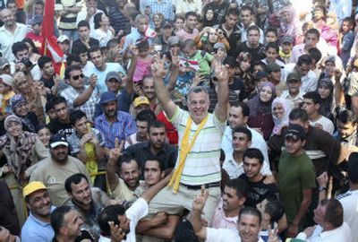 
A crowd carries Nasim Nisr in his home village of Bazouriyeh, Lebanon, on Sunday. He was released Sunday after spending six years in prison in Israel on charges of spying for Hezbollah. Associated Press photos
 (Associated Press photos / The Spokesman-Review)