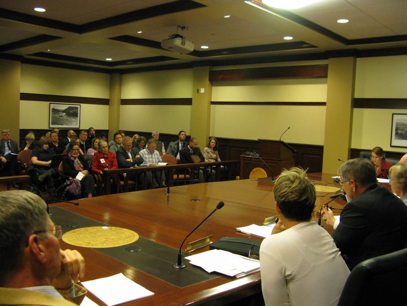 Idaho state Board of Education members discuss a controversial tiered teacher licensing rule on Thursday, before a standing-room only audience in the state Capitol (Betsy Russell)
