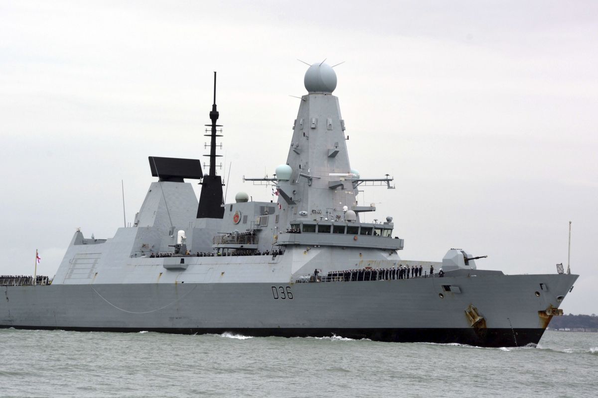 FILE - This March 20, 2020 file photo shows HMS Defender in Portsmouth, England. The Russian military says its warship has fired warning shots and a warplane dropped bombs to force the British destroyer from Russia