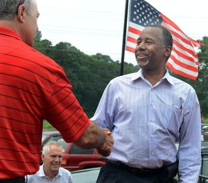 Republican presidential candidate Dr. Ben Carson, right, shakes hands with Bill Conley as he arrives to speak at The Beacon restaurant in Spartanburg, S.C., earlier this month. (John Byrum / Spartanburg Herald-Journal via AP)