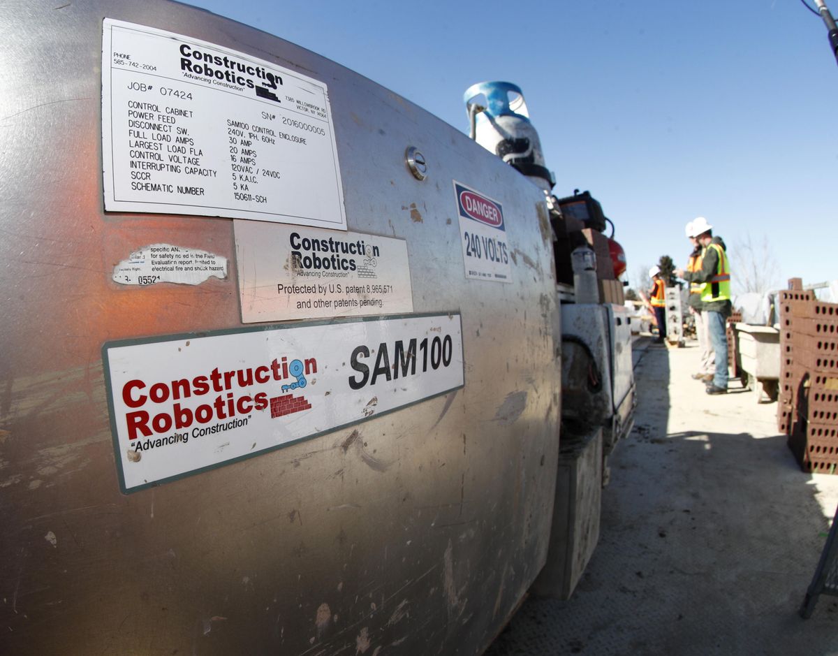 Samantha, a robotic bricklayer, is shown at work on the facade of a school in the south Denver suburb of Englewood, Colo., on Tuesday, Feb. 27, 2018. (Associated Press)