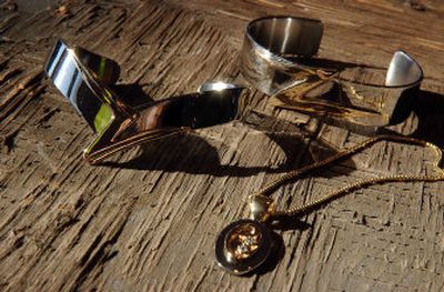 
Dan Zasso had Pounder's Jewelry make bracelets made from the dance floor where he and his wife met. The jewelry is pictured on top of the dance floor that is metal with wood on top. 
 (Jed Conklin / The Spokesman-Review)