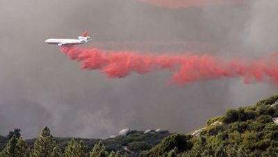 
A modified DC-10 drops fire retardant on a nearly 62-square-mile wildfire Friday in Idyllwild, Calif. 
 (Associated Press / The Spokesman-Review)