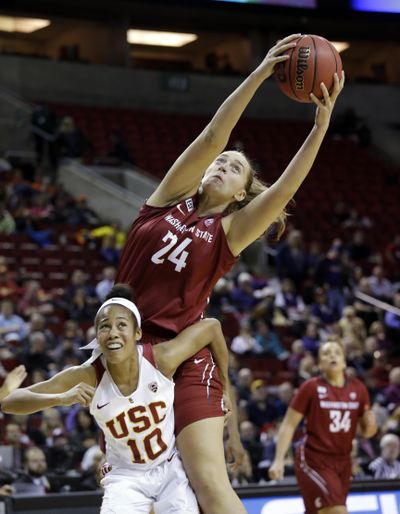 Washington State's Bianca Blanaru (24) grabs a rebound over Southern California's Courtney Jaco during the second half of an NCAA college basketball game in the Pac-12 women's tournament, Thursday, in Seattle. USC won 77-73. (Elaine Thompson / Associated Press)