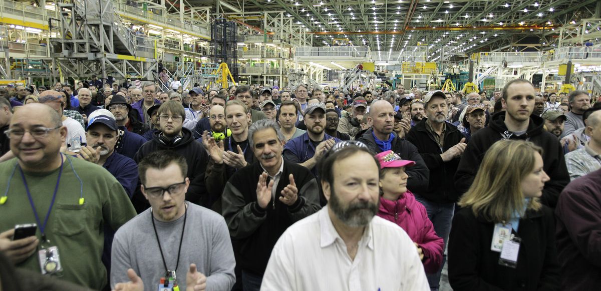 Boeing Co. employees cheer during a rally at Boeing’s 767 assembly plant in Everett on Friday. The rally was held to celebrate Boeing winning a $35 billion Air Force contract for a new aerial tanker fleet. (Associated Press)