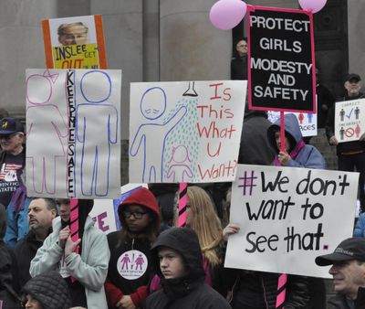 Protesters on the steps of the Capitol challenge a rule by the Human Rights Commission that allows people to use public restrooms and locker rooms based on gender identity. Supporters of the rule gathered nearby on the Temple of Justice steps. (Jim Camden / The Spokesman-Review)